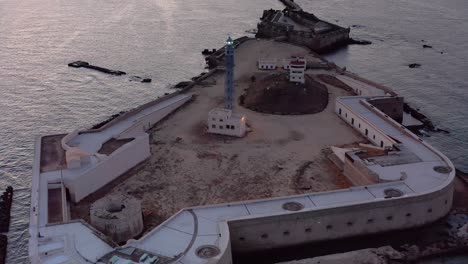 aerial view of a historic lighthouse and fortress on an island