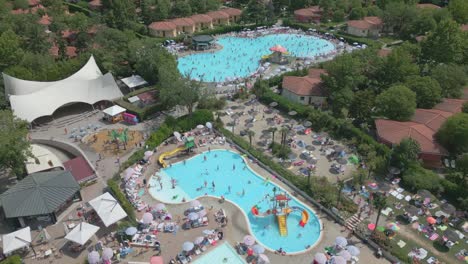 birds eye view drone shot large holiday resort with outdoor swimming pool