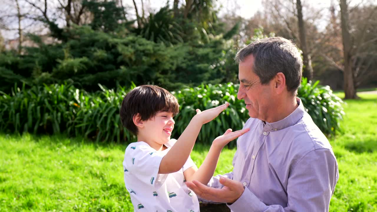 Grandfather and grandson in park