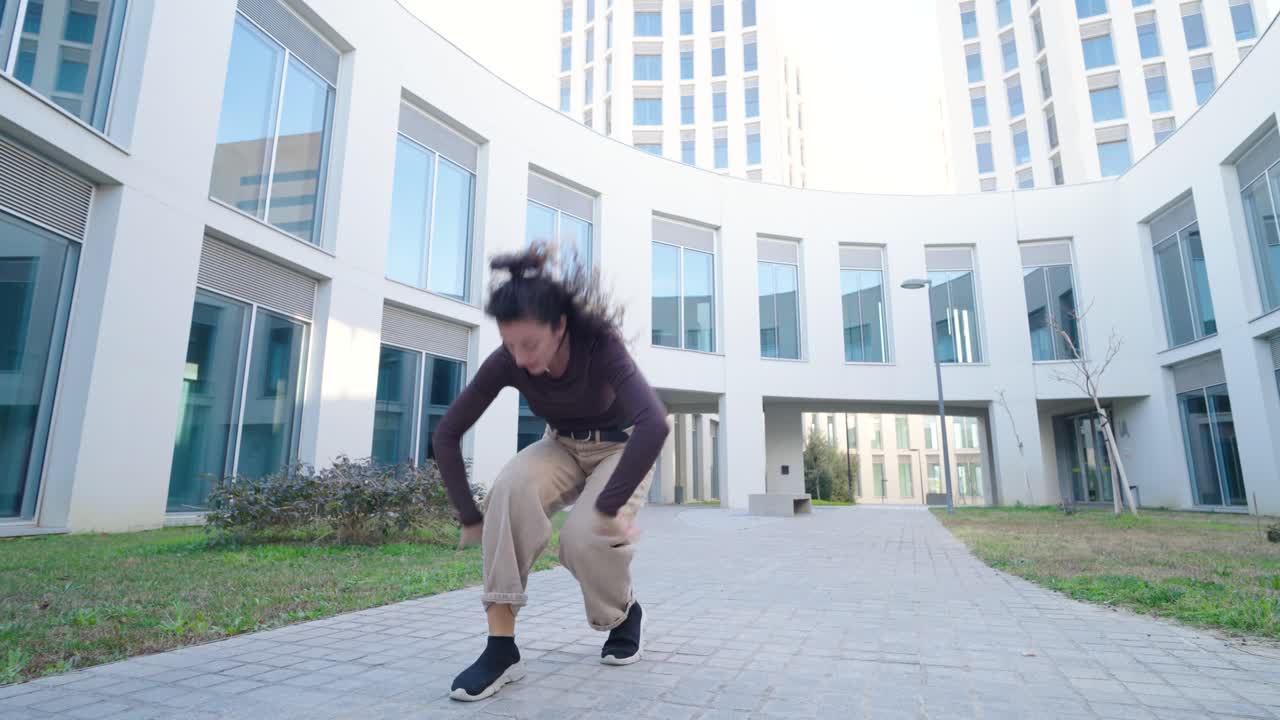 Young woman dancing modern choreography outdoors