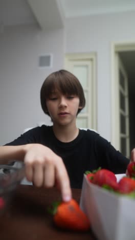 boy eating strawberries