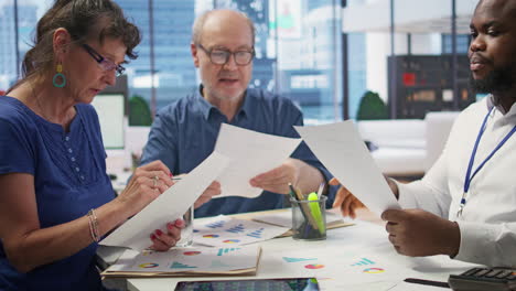 elderly people exploring a detailed pension plan with financial advisor