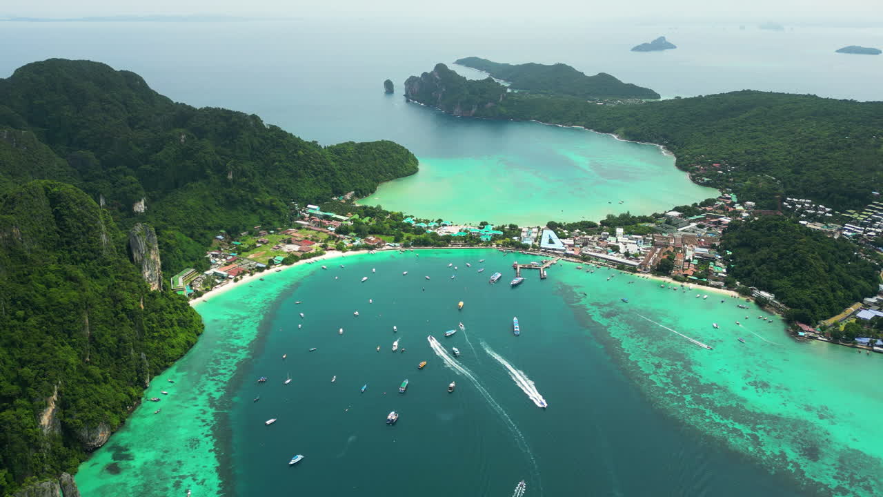 Turquoise lagoon and popular travel resort Koh Phi Phi, Thailand, aerial orbit