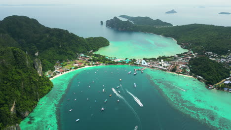 Turquoise-lagoon-and-popular-travel-resort-Koh-Phi-Phi,-Thailand,-aerial-orbit