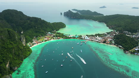 turquoise lagoon and popular travel resort koh phi phi, thailand, aerial orbit