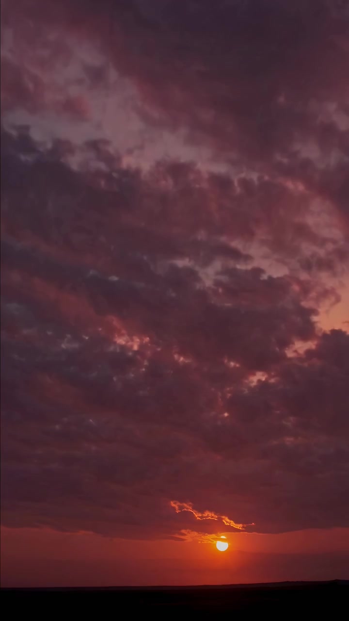 Time Lapse of Sun Setting Behind Clouds in Evening Sky