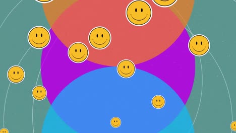 animation of smiley faces, floating over three colourful circles, on green
