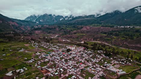 Slow-descent-with-drone-to-Maca-village-in-Colca-Valley,-ending-with-a-close-up-of-the-church