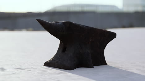 old anvil on a sandy beach