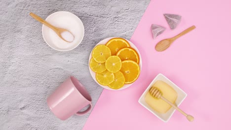 cup for tea, honey, sugar move around sliced lemons. stop motion