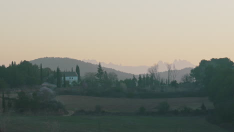 farm house in green field valley during misty early morning