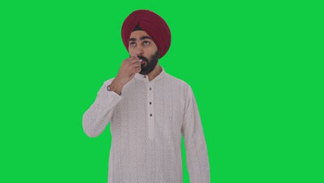 sick sikh indian man measuring fever using thermometer green screen