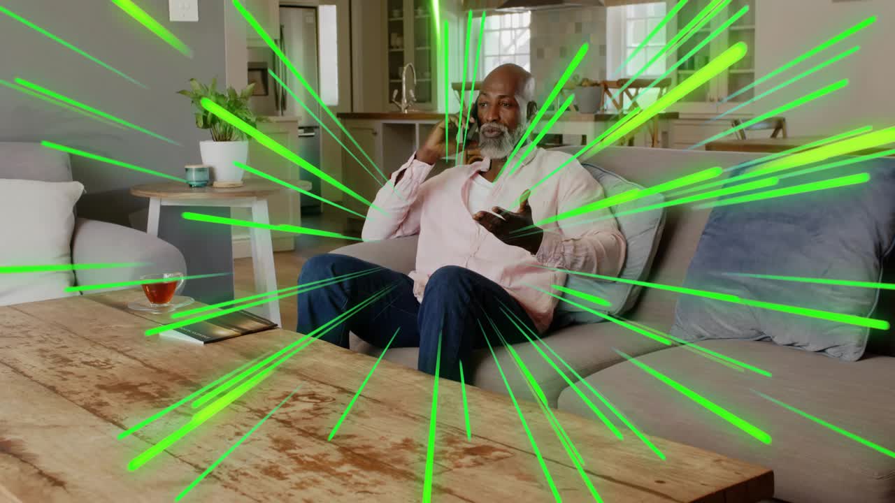 Senior man placing book picking up phone calling with green streaks radiating behind him for tech