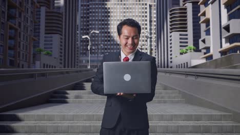businessman using laptop outdoors