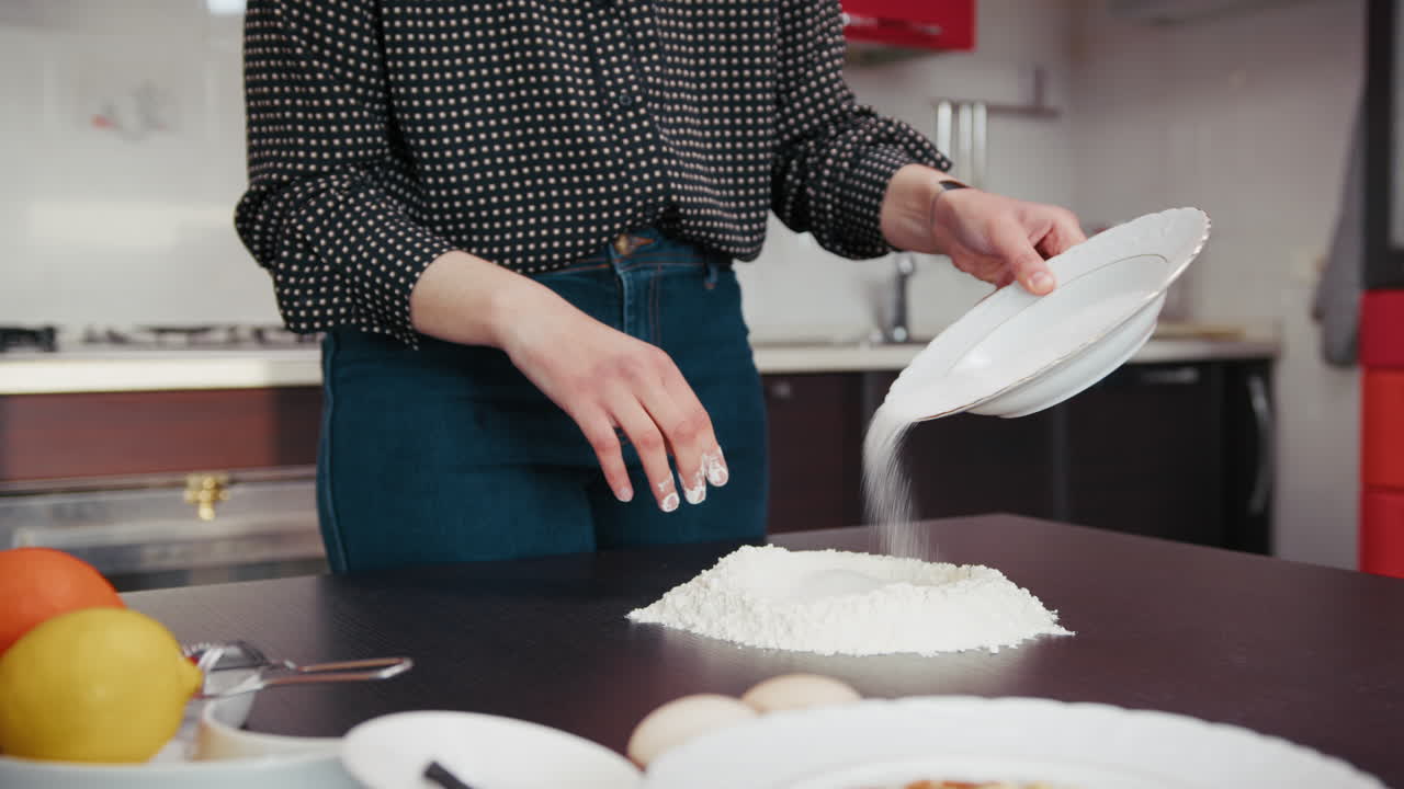 Young Woman Puts Flour On A Table For The Preparation Of A Typical Dessert