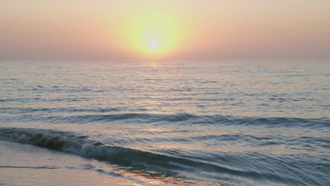 fixed footage of a sunset at the sea in slow motion