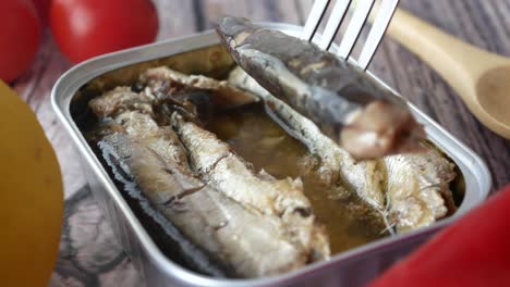 close-up of a can of sardines with a fork