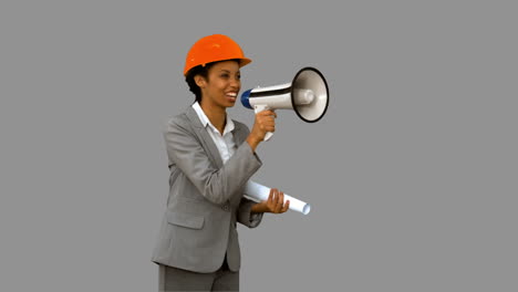 Happy-architect-using-a-megaphone-on-grey-screen