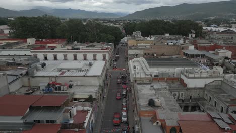 colorful flags flutter over narrow streets in mexican city of oaxaca