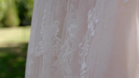 wedding-dress-hanging-in-tree-before-wedding-pan-up-shot