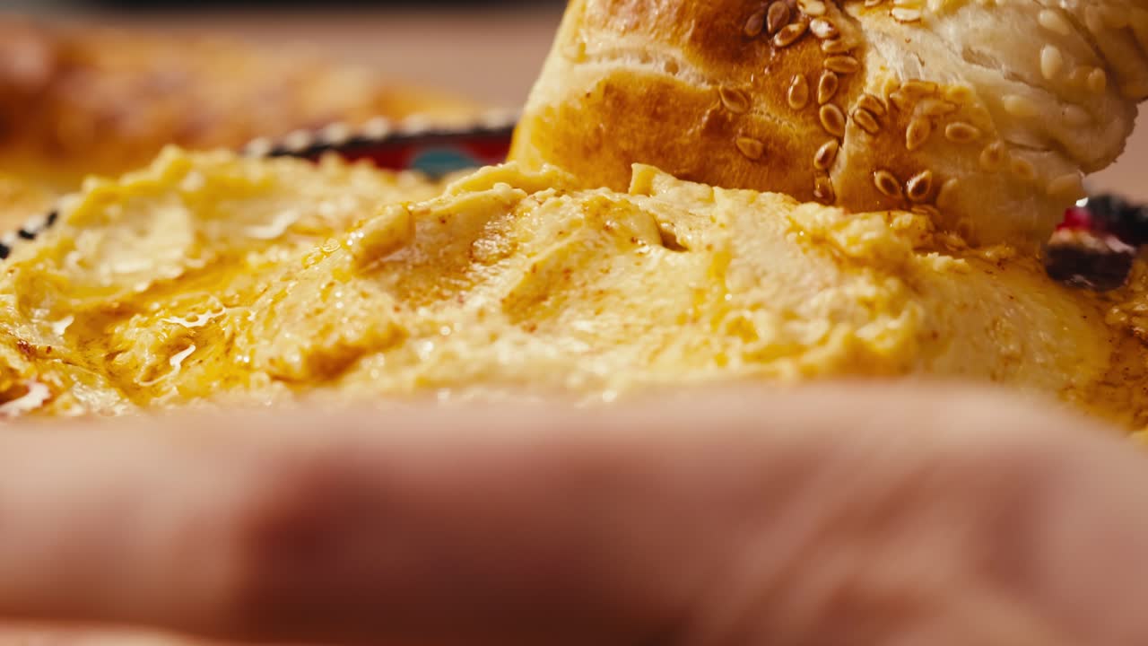 Dipping Bread in Hummus