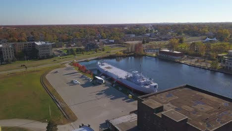 rotating aerial shot of old tank landing ship uss lst 393 in muskegon