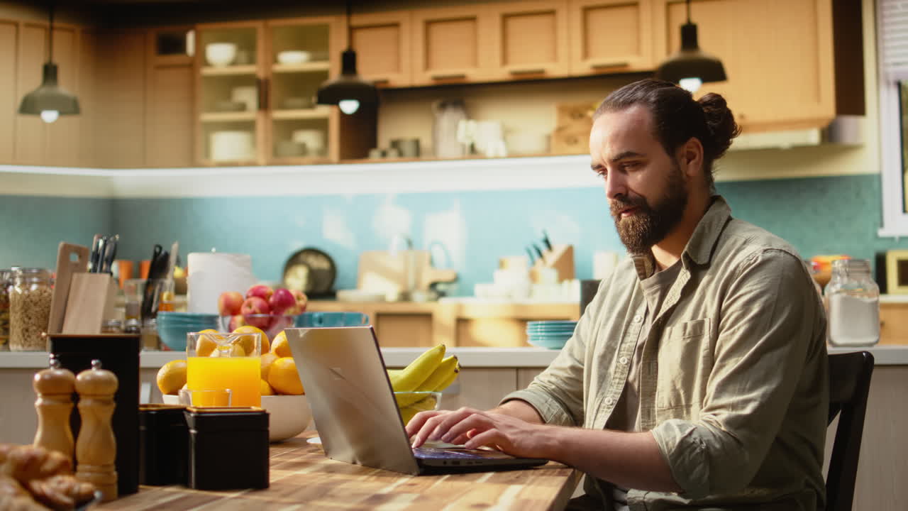 Man working remotely from his home setup in the kitchen