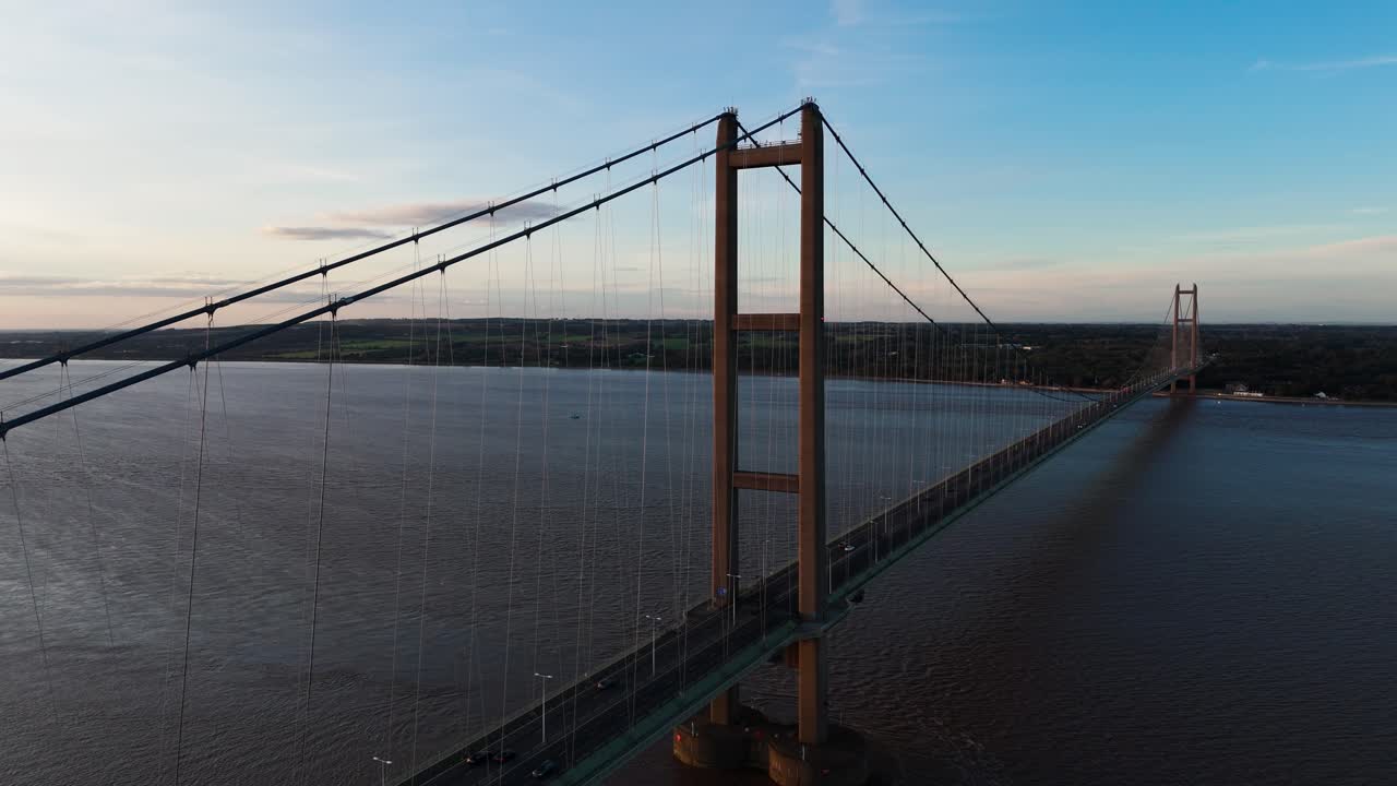 Serenity meets motion: Humber Bridge basks in sunset's glow, with an aerial drone capturing cars in harmonious transit