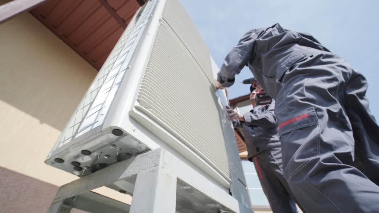 HVAC technician installs heating, ventilation and air conditioning systems on site