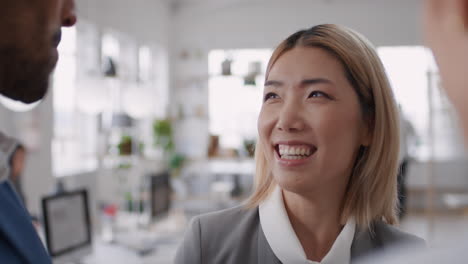 beautiful asian business woman chatting with clients smiling enjoying developing corporate partnership discussing project in modern office workspace