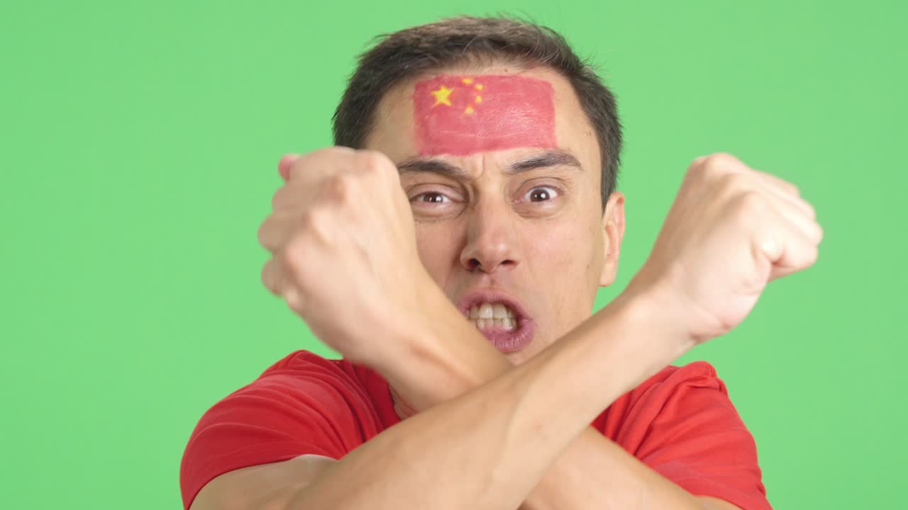 Man with chinese national flag upset with a football referee