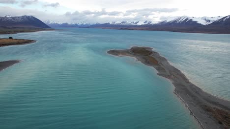 snowy mountain range from lake tekapo in canterbury region, south island, new zealand. - aerial shot