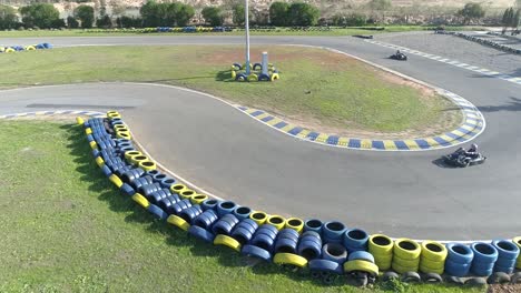 aerial flyover carting go kart track during go kart race during sunny day