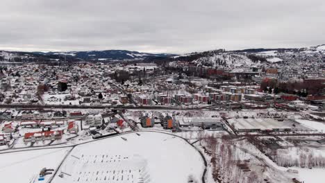 Wide-dolly-aerial-over-student-city-Gjövik-in-Norway-on-winter-day