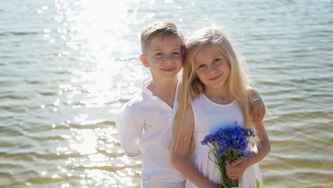 Boy Gives Flowers to Girl Happy Children Romantic Gift to Little Girl Brother and Sister Boy Gives Flowers to Girl Happy Children Romantic Gift to Little Girl Brother and Sister