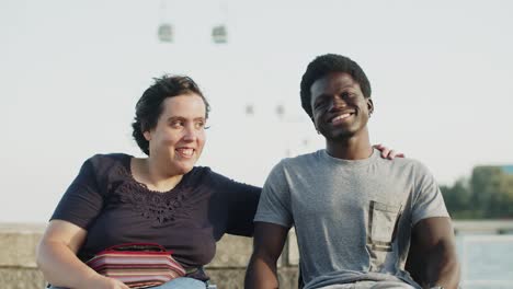 portrait of happy couple using wheelchairs embracing