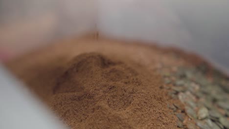 Close-Up-on-hand-taking-brown-flour-for-quality-inspections