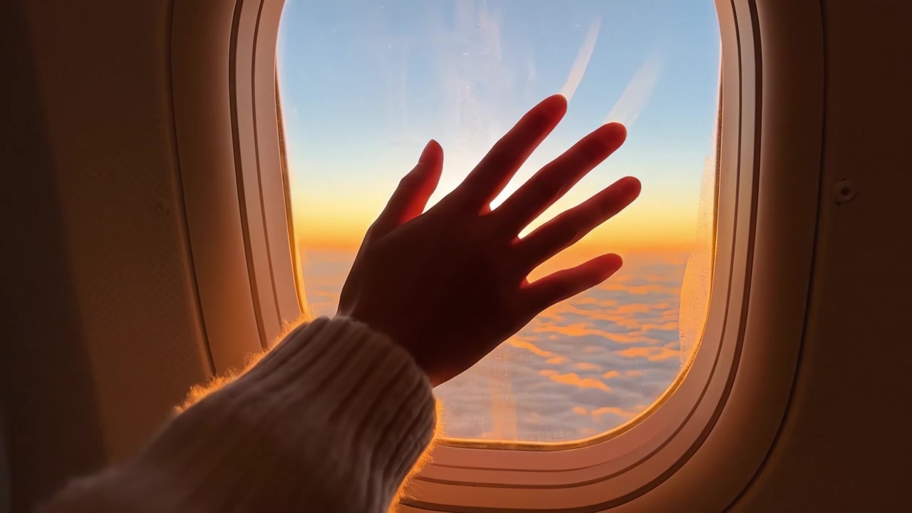 A Breathtaking Sunset View from an Airplane Window, Capturing the Golden Sun Glowing Above a Sea of Clouds, Invoking a Sense of Freedom and Tranquility