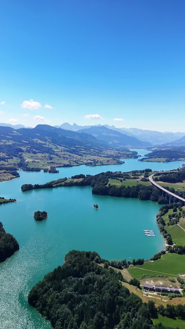 Lake of Gruyère in Switzerland, aerial drone vertical nature video alpine region