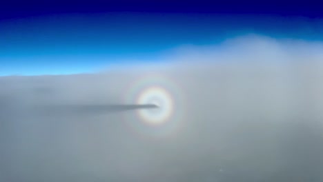 Awesome-view-of-the-halo-of-a-jet-and-shadow-flying-in-a-layer-of-thin-stratus-during-cruise-level-at-12000-metres-high