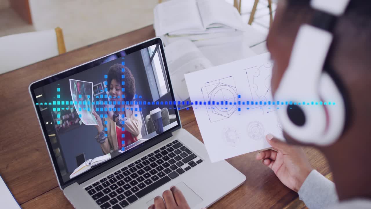 Teacher speaking on laptop, student lifting sketch responding, blue waveform guiding design review