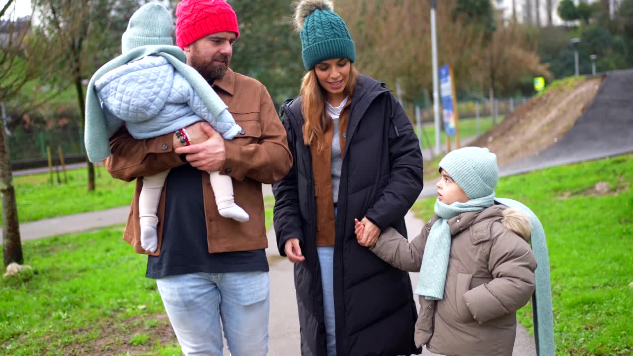 Family enjoying a walk in the park during winter