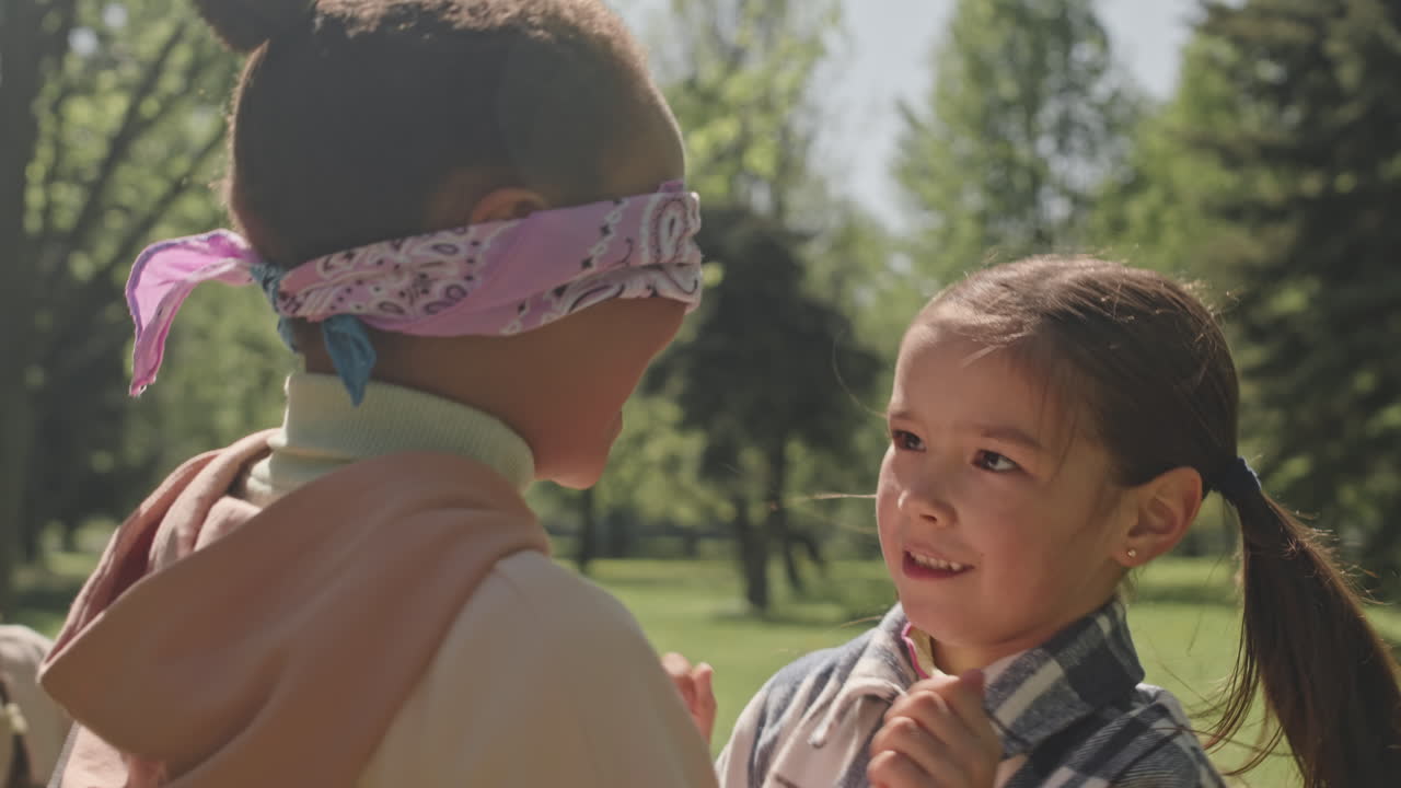 Children Play Blind Man's Bluff in the Park