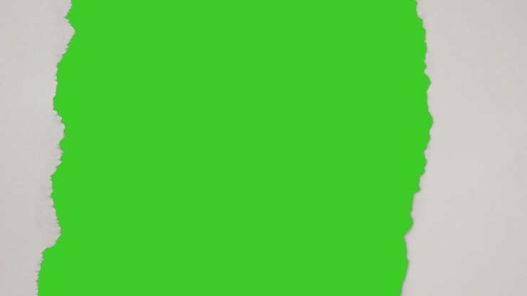 Close Up Of Strip Of Paper Being Torn Off Uncovering Green Screen Background Below 5