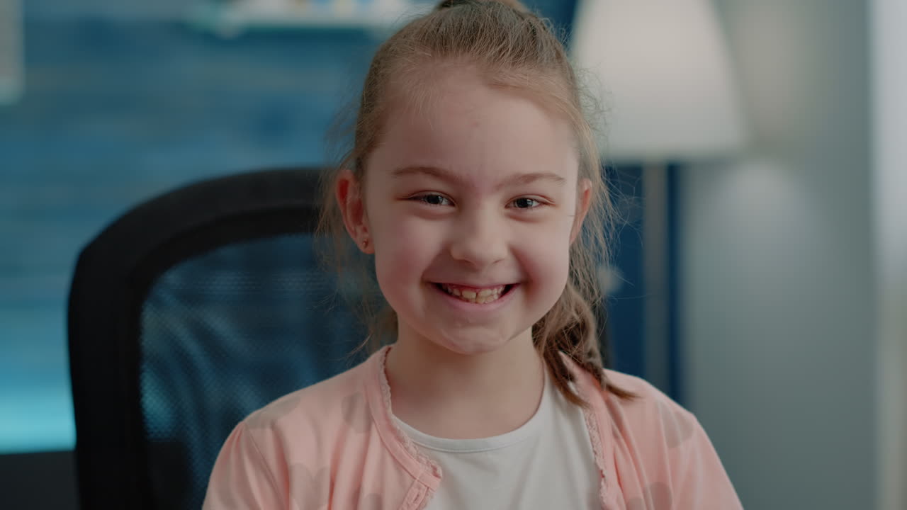 Close up of little girl sitting at desk and preparing to do homework