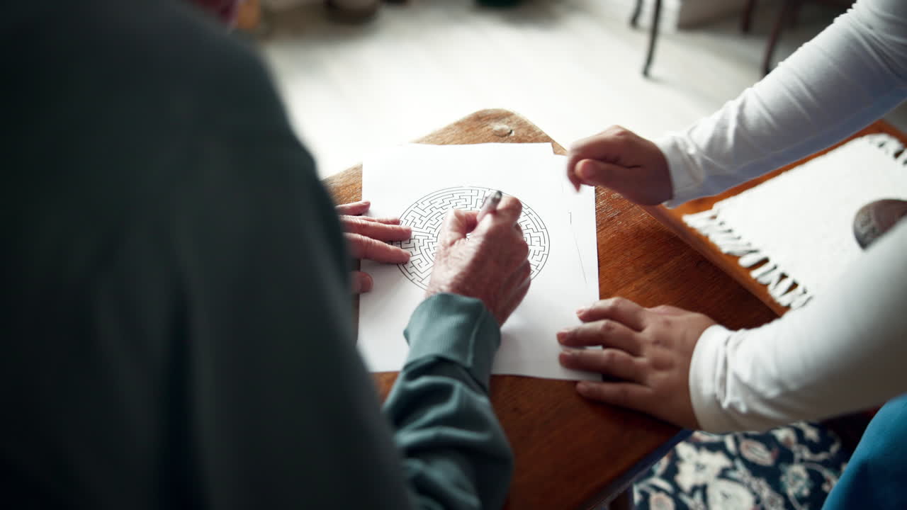 Senior citizen and child solving a maze puzzle together