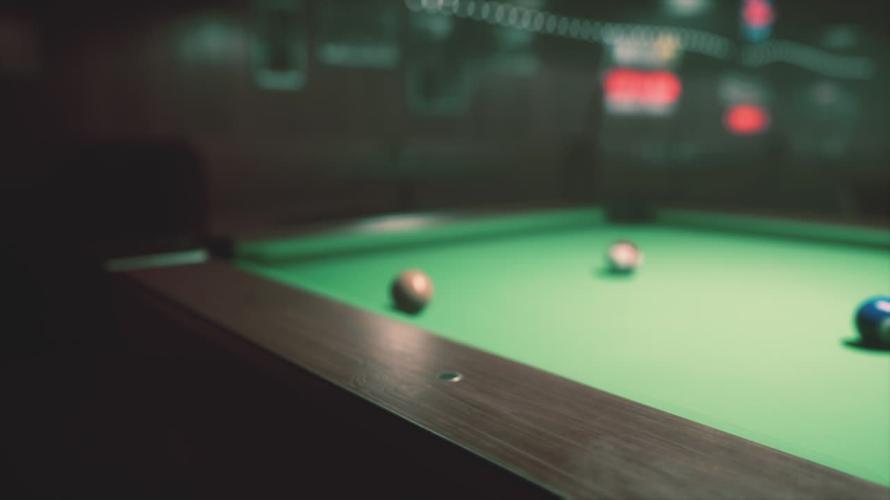 A close-up of a pool table with balls on it
