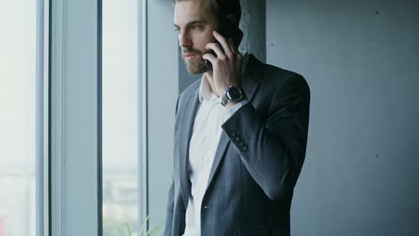 businessman on phone by window