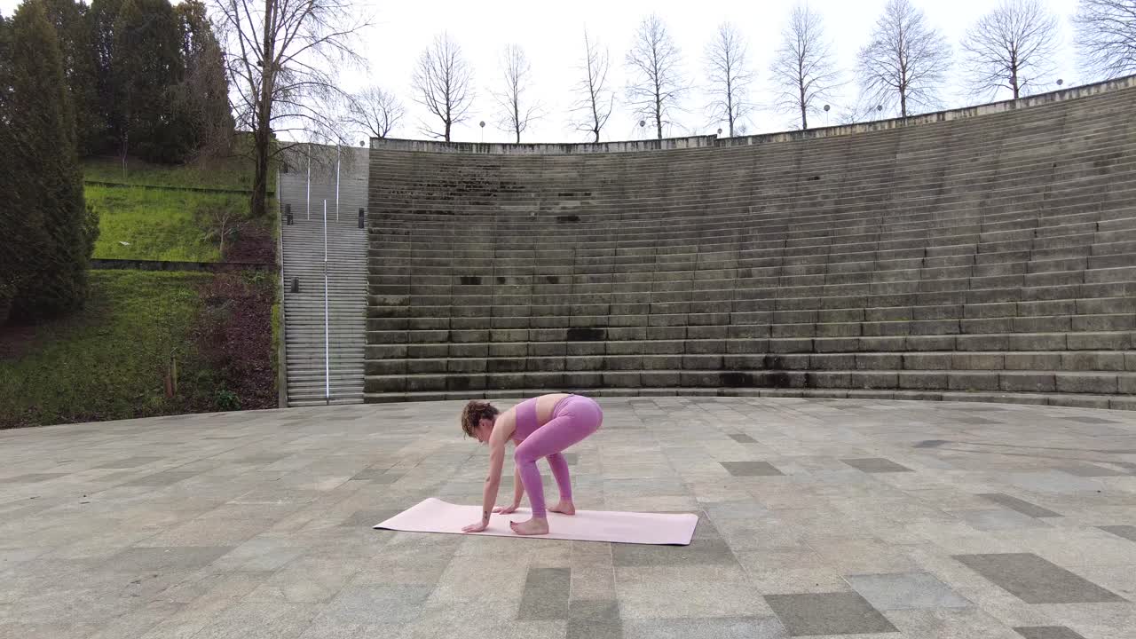 Woman doing yoga in an amphitheater