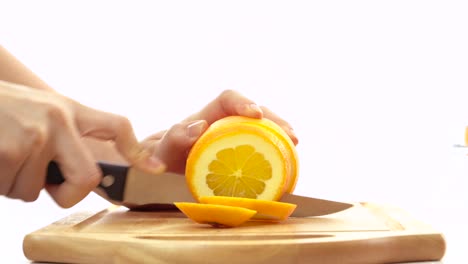 knife slicing fresh orange